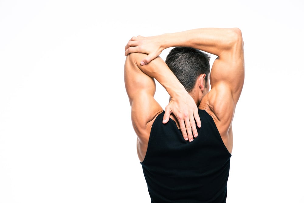 Back view portrait of a muscular man stretching hands isolated on a white background